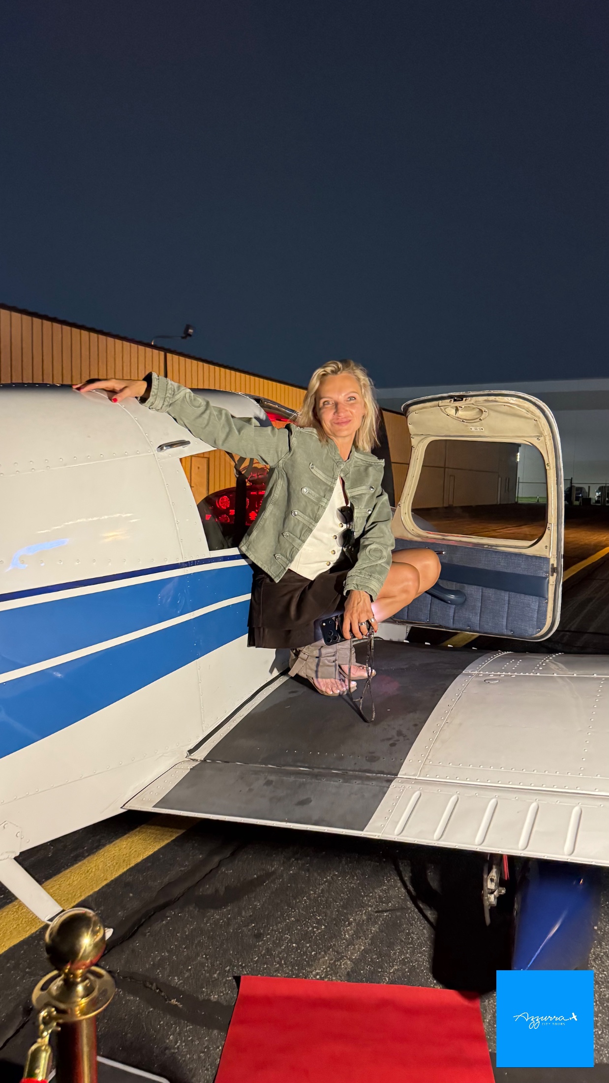 The wing of the Piper Cherokee PA-28 framing the New York City skyline on Helena P.'s August 2026 flight